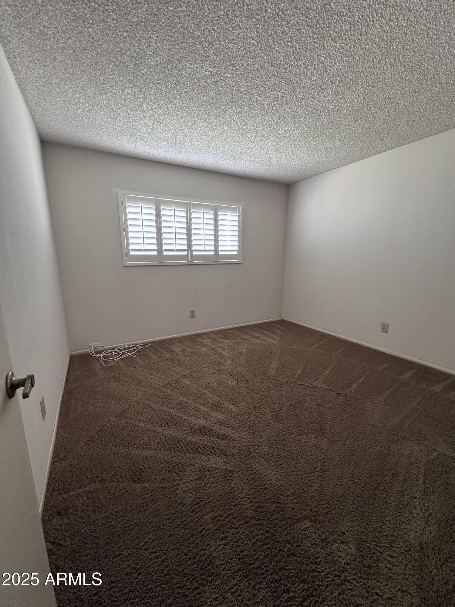 5507 West Hearn Road Glendale, AZ 85306 - Photo 13 of 19 an empty room with a window