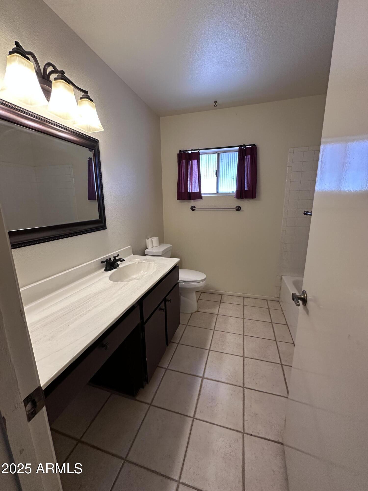 5507 West Hearn Road Glendale, AZ 85306 - Photo 14 of 19 a bathroom with a sink vanity and a mirror