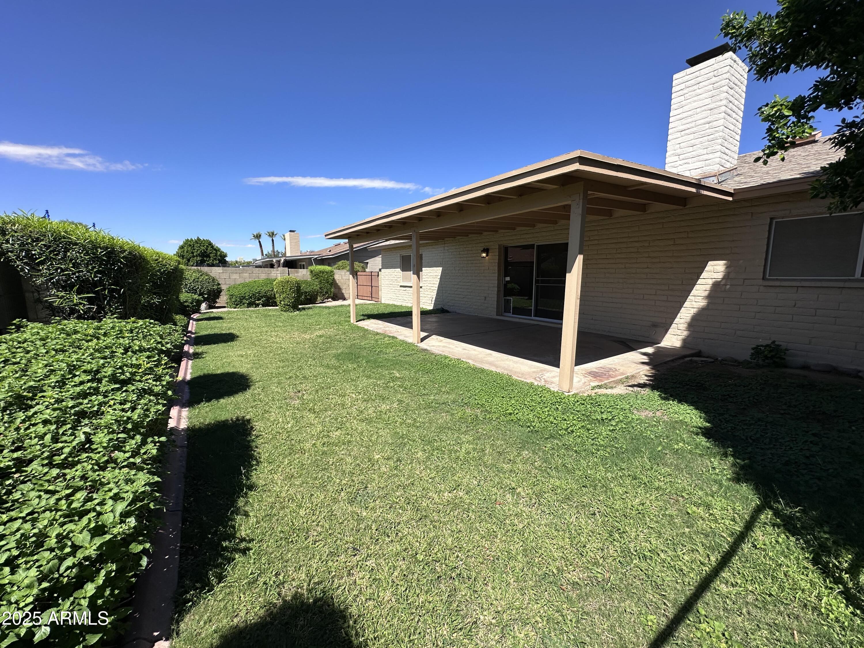 5507 West Hearn Road Glendale, AZ 85306 - Photo 19 of 19 a front view of a house with garden
