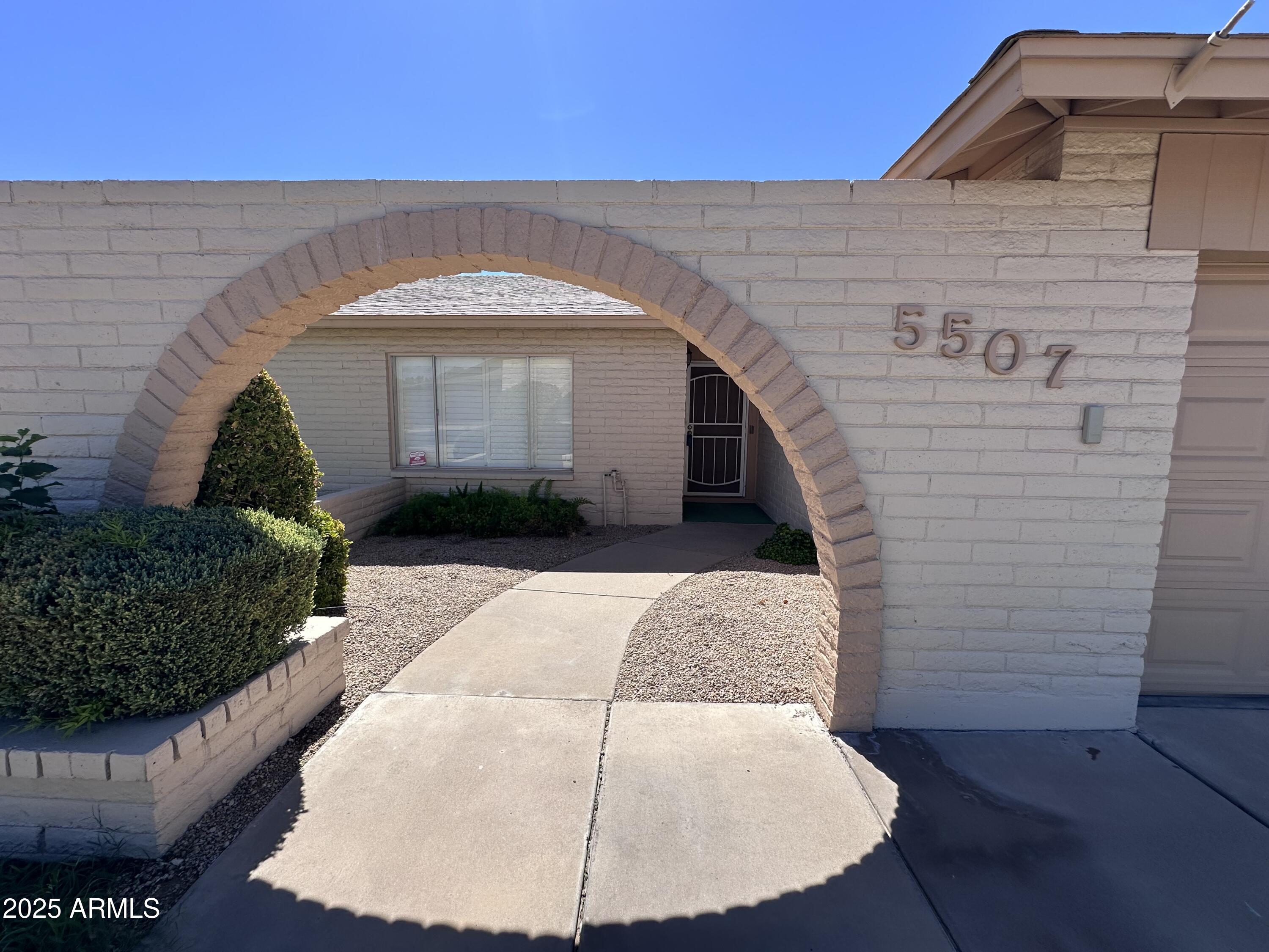 5507 West Hearn Road Glendale, AZ 85306 - Photo 3 of 19 a front view of a house with a yard