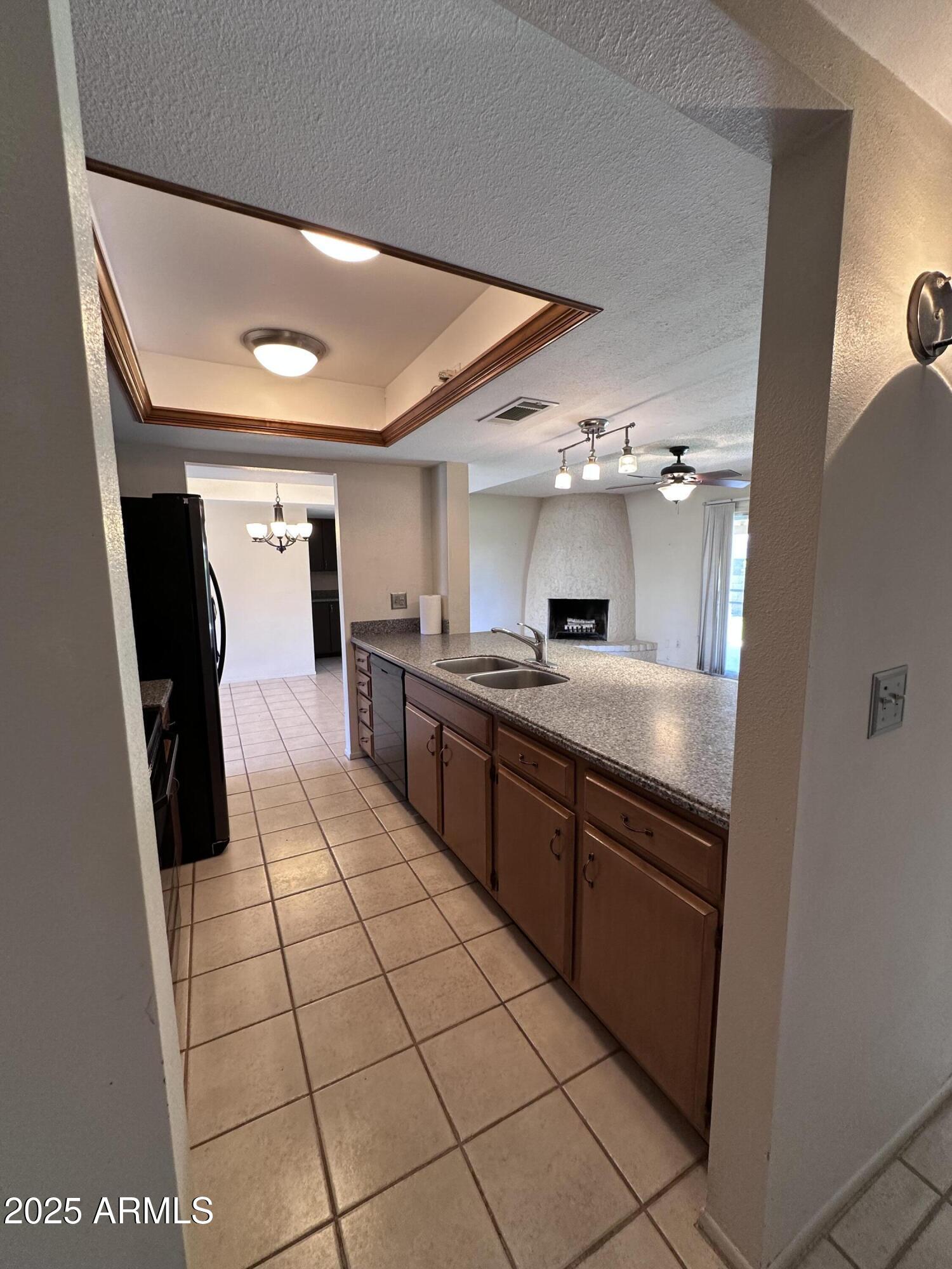 5507 West Hearn Road Glendale, AZ 85306 - Photo 8 of 19 a large white kitchen with a sink a counter top space and stainless steel appliances