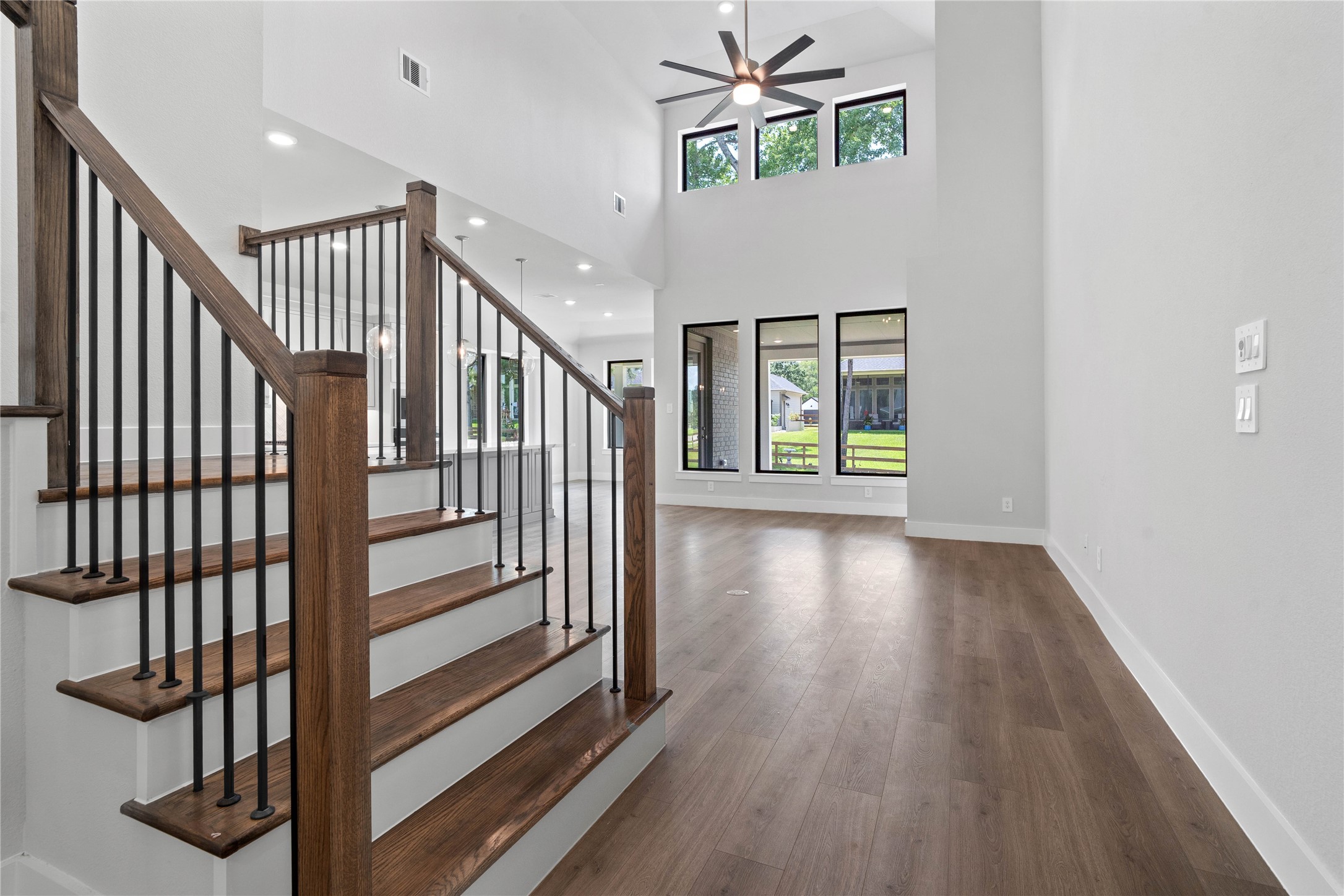 551 Black Bronco Road Magnolia, TX 77354 - Photo 13 of 50 Enjoy an open, airy living experience with a wall of windows that flood the Great Room with abundant light and clear views of the rear covered patio and backyard space.