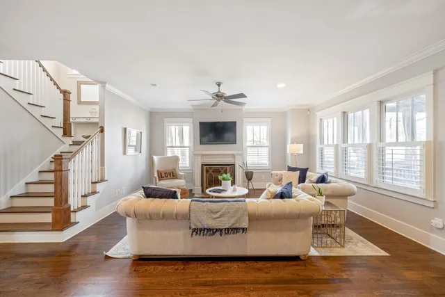 a living room with fireplace furniture and a wooden floor