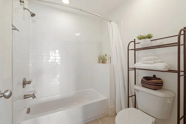 a bathroom with a shower a toilet and a sink