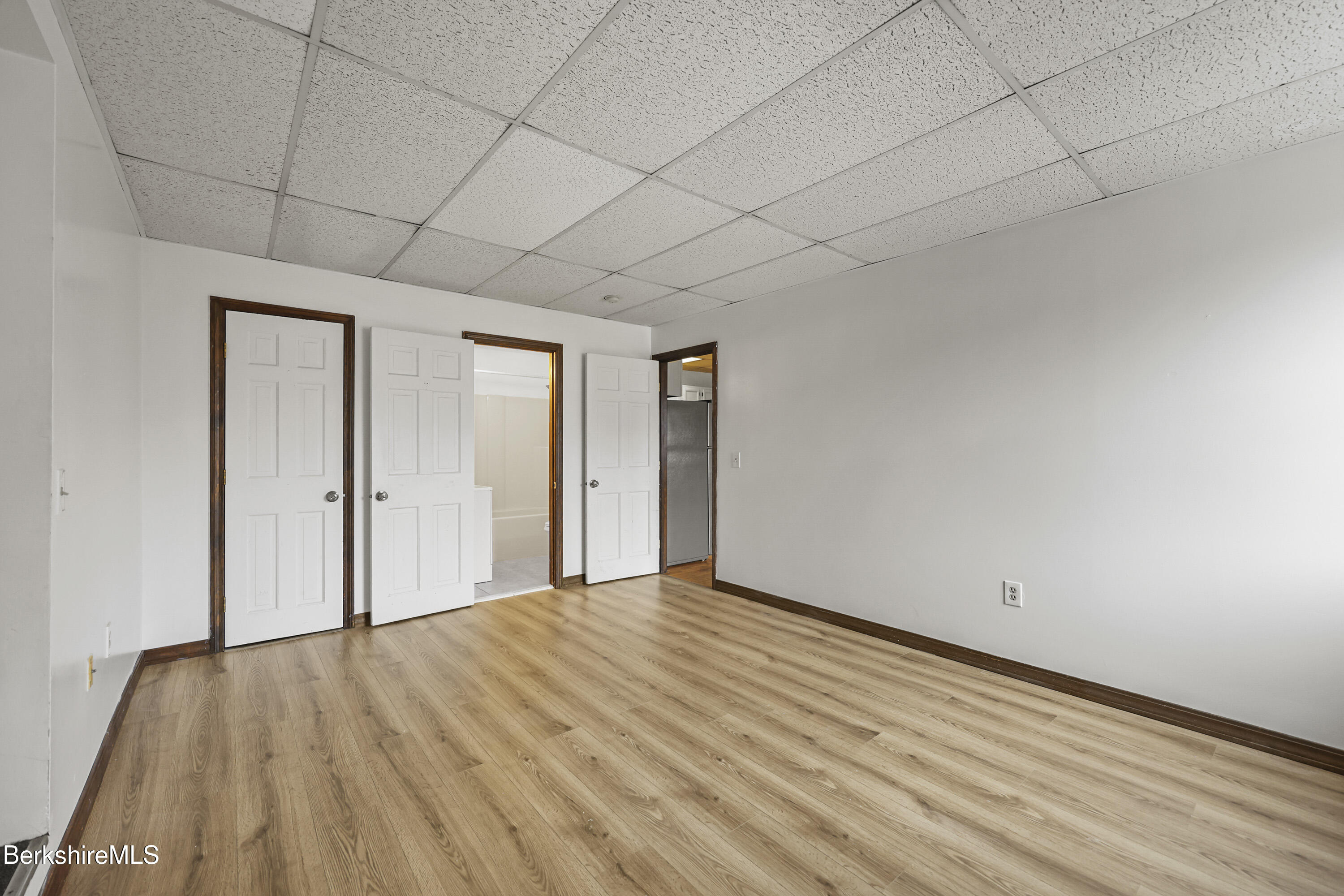 55 Crystal Street, Unit 8 Lenox, MA 01242 - Photo 11 of 12 a view of an empty room with wooden floor