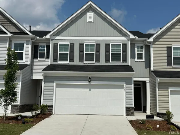 a front view of a house with a garage
