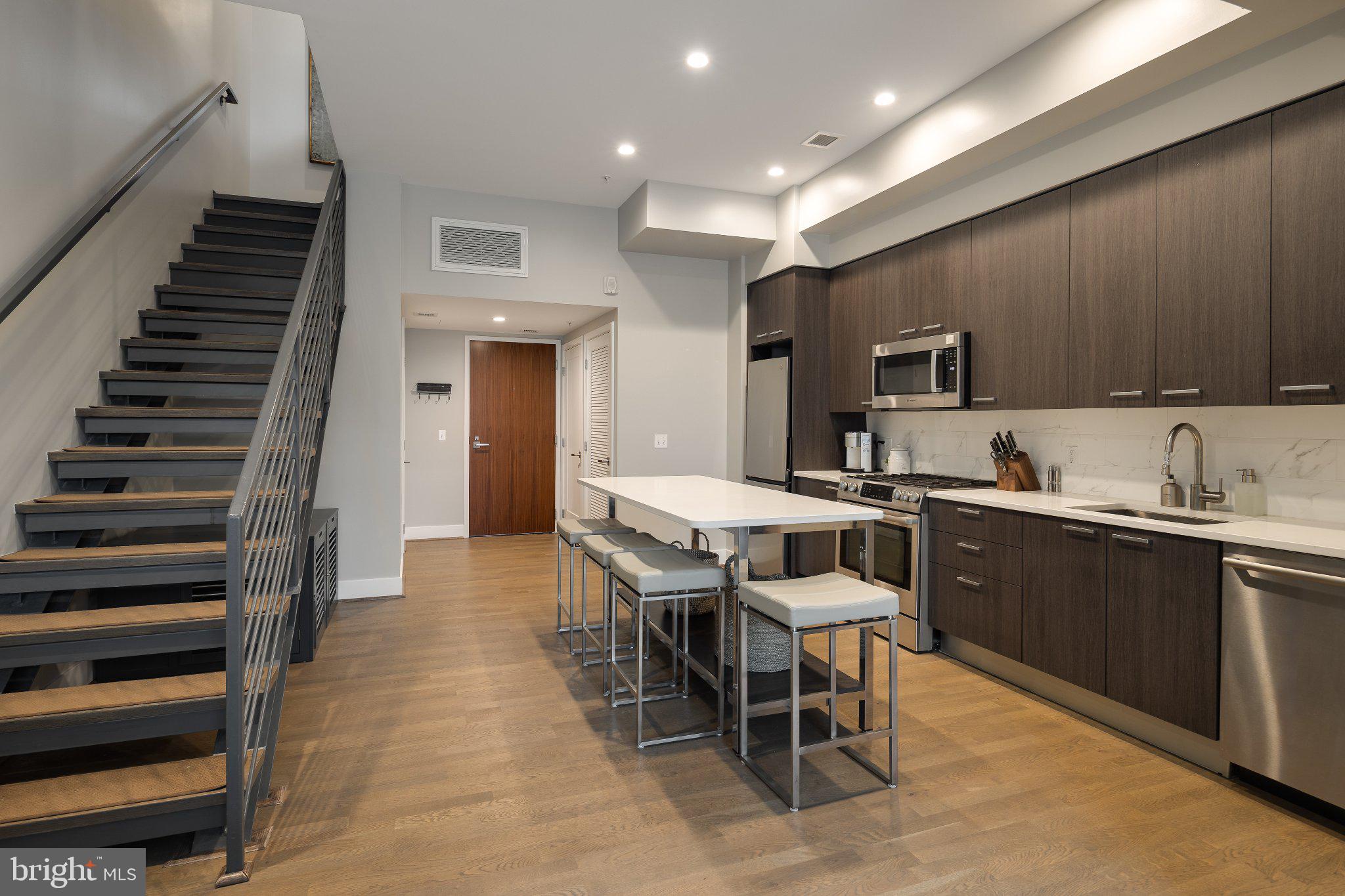 525 Southwest Water Street Southwest, Unit 404 Washington, DC 20024 - Photo 2 of 82 a kitchen with sink cabinets and appliances
