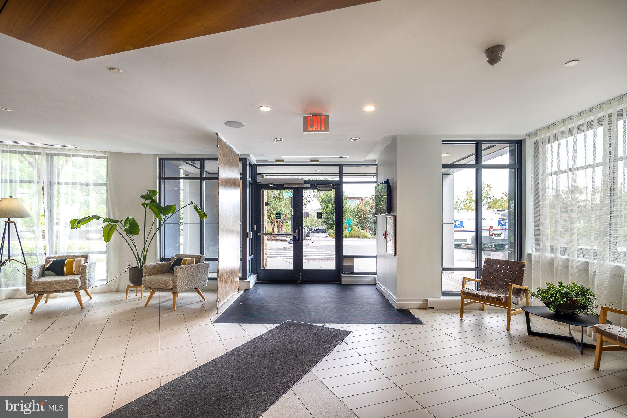 525 Southwest Water Street Southwest, Unit 404 Washington, DC 20024 - Photo 24 of 82 a living room with furniture large windows and wooden floor