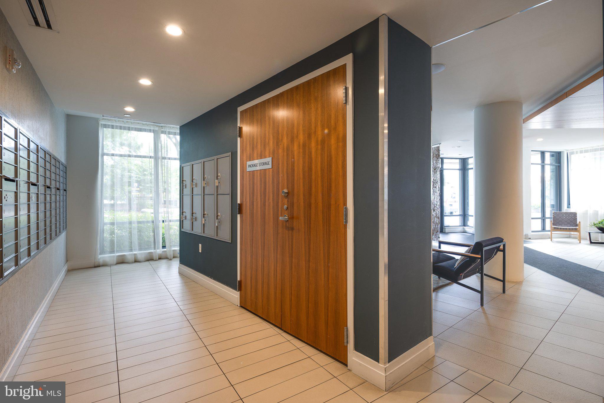 525 Southwest Water Street Southwest, Unit 404 Washington, DC 20024 - Photo 26 of 82 a view of a hallway with bathroom and glass door