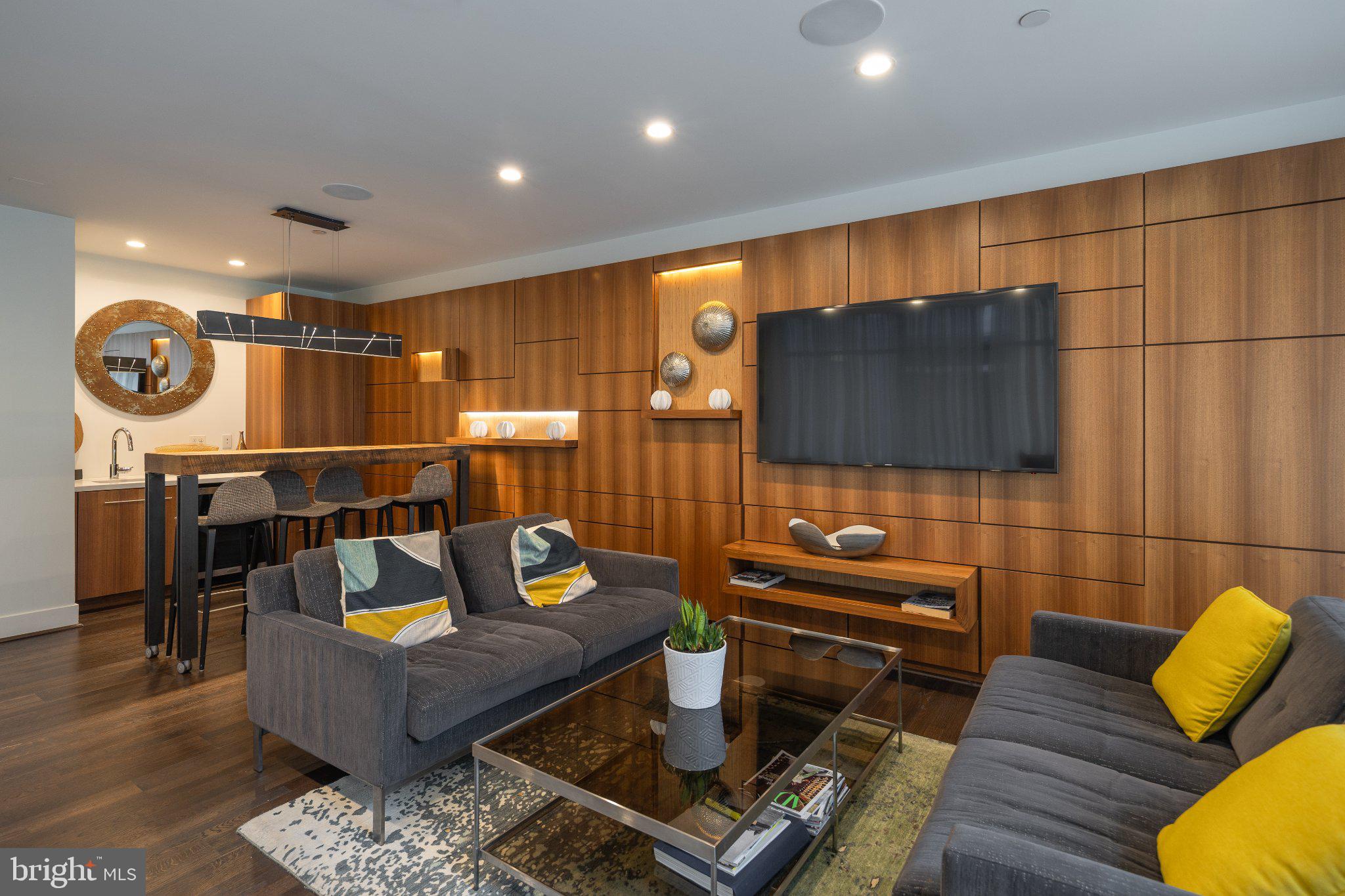 525 Southwest Water Street Southwest, Unit 404 Washington, DC 20024 - Photo 32 of 82 a living room with furniture and a flat screen tv