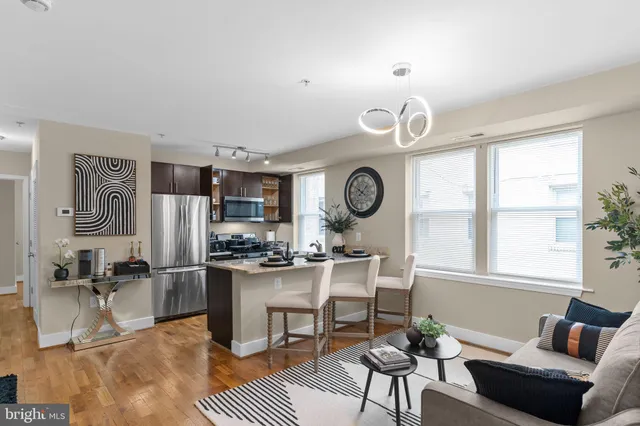 a living room with kitchen island furniture and a window