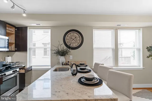 a kitchen with a stove a sink and a window