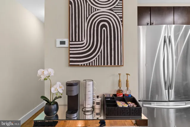 a kitchen with refrigerator and cabinets