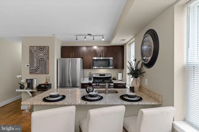 a kitchen with stainless steel appliances a sink and a stove
