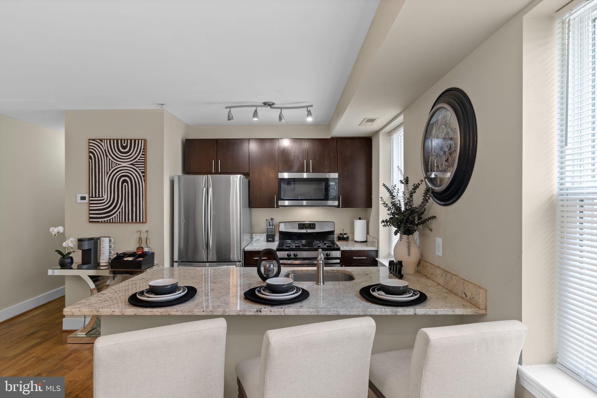 417 18th Street Northeast, Unit 104 Washington, DC 20002 - Photo 24 of 40 a kitchen with stainless steel appliances a sink and a stove