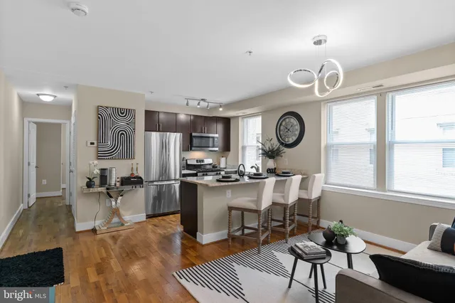 a large kitchen with a table and chairs