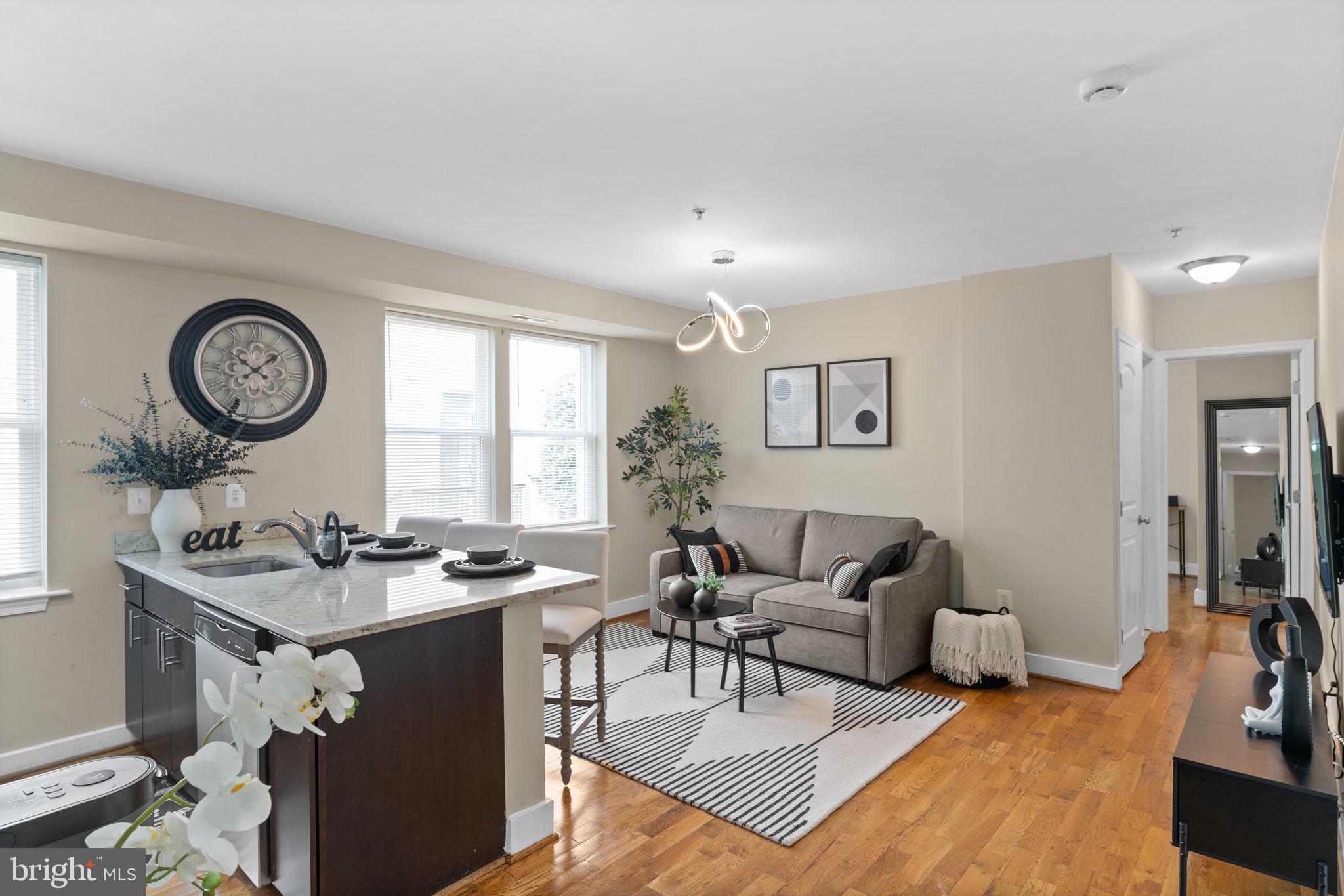 417 18th Street Northeast, Unit 104 Washington, DC 20002 - Photo 27 of 40 a living room with furniture a clock on wall and a window