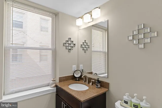 a bathroom with a sink a mirror and a window