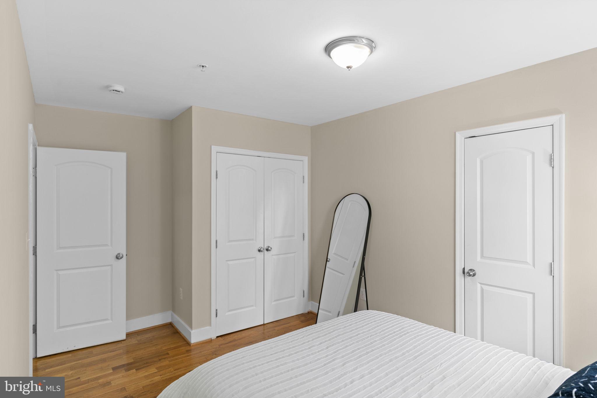 417 18th Street Northeast, Unit 104 Washington, DC 20002 - Photo 31 of 40 a bedroom with a bed and wooden floor