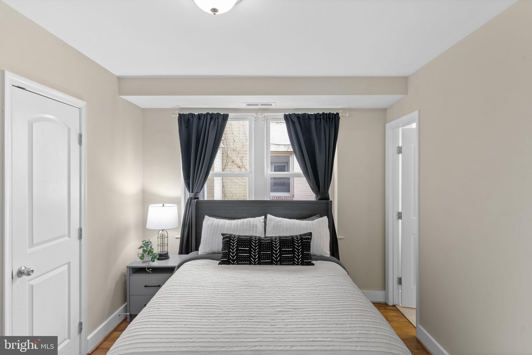 417 18th Street Northeast, Unit 104 Washington, DC 20002 - Photo 32 of 40 a bed room with a bed and a window