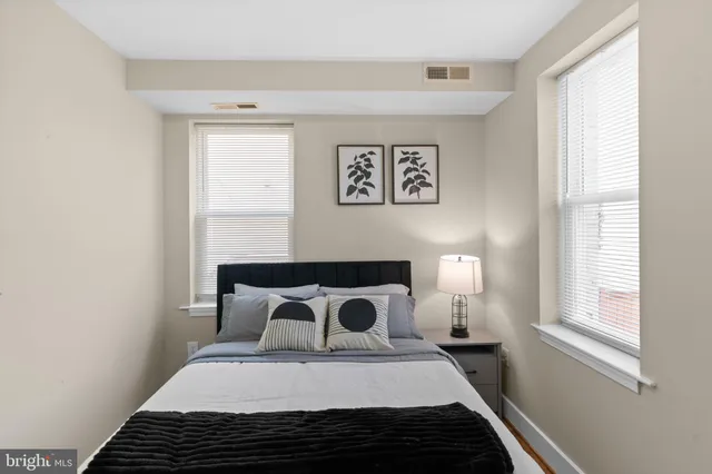 a bedroom with a bed and a window