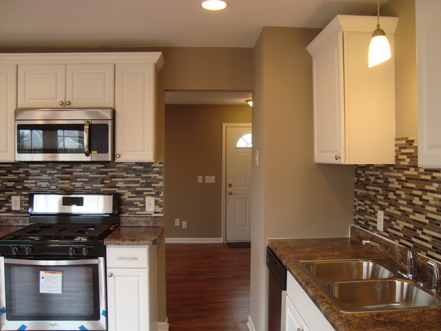 151 Heathgate Road Montgomery, IL 60538 - Photo 6 of 23 a kitchen with granite countertop a sink and a stove top oven