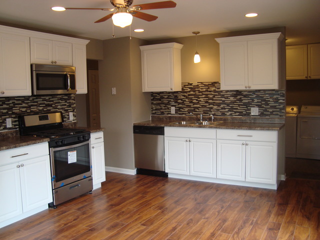 151 Heathgate Road Montgomery, IL 60538 - Photo 8 of 23 a kitchen with stainless steel appliances granite countertop a stove and a sink