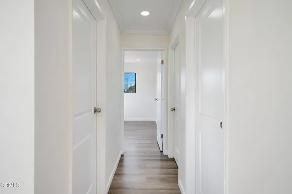 a view of a hallway with wooden floor