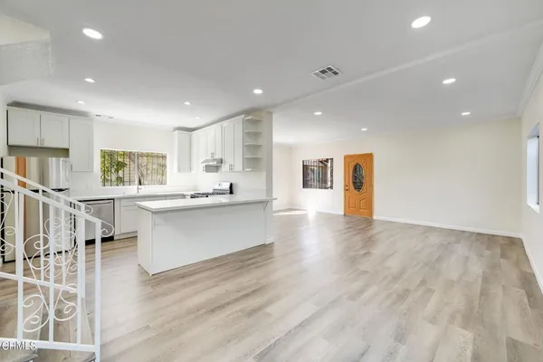 a view of kitchen with cabinets and wooden floor