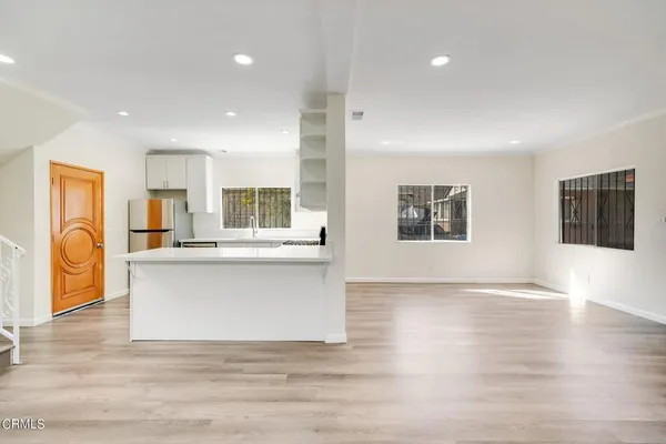 a view of living room with wooden floor and windows