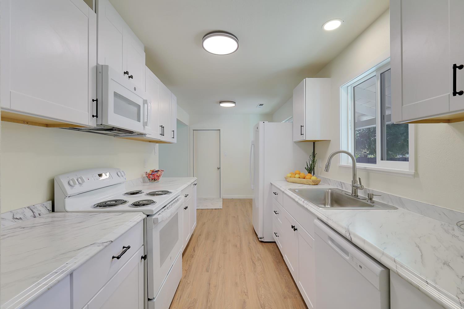 10673 Alta Street Grass Valley, CA 95945 - Photo 11 of 38 a kitchen with stainless steel appliances a sink stove and cabinets