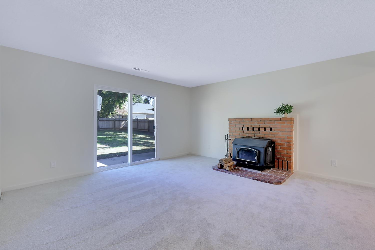 10673 Alta Street Grass Valley, CA 95945 - Photo 15 of 38 a view of a livingroom with a fireplace and a window