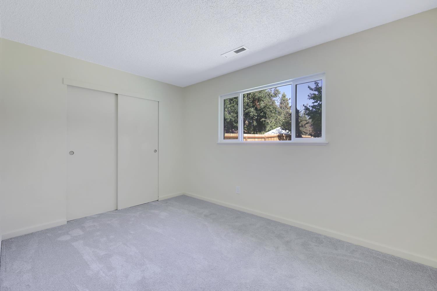 10673 Alta Street Grass Valley, CA 95945 - Photo 21 of 38 a view of an empty room with a window