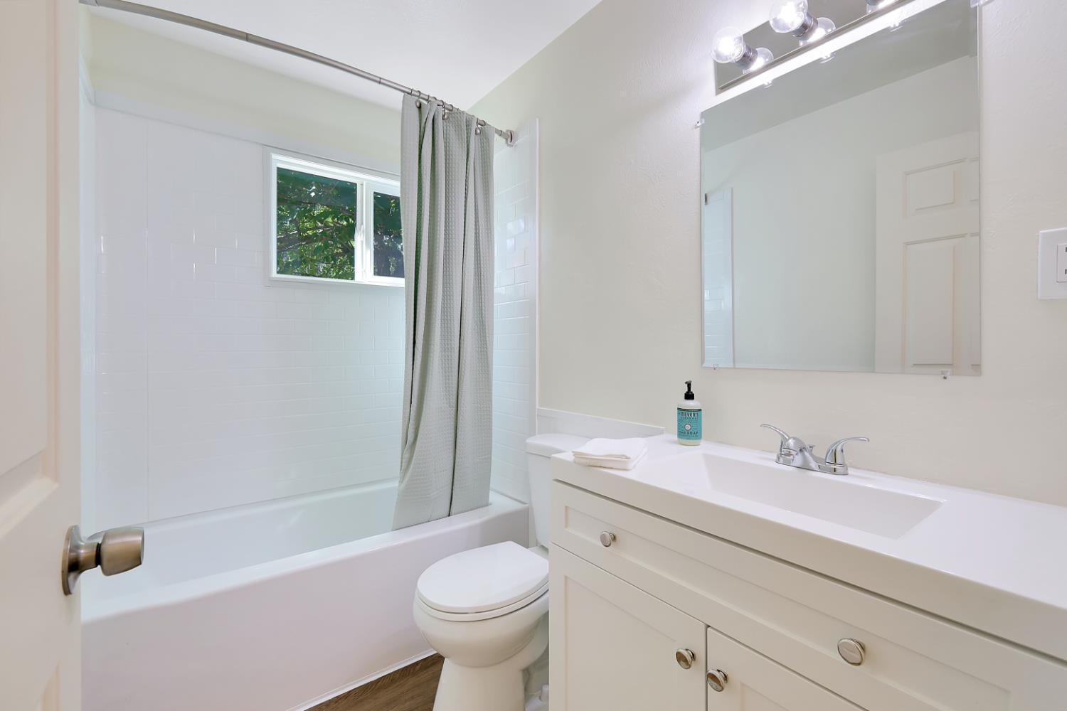 10673 Alta Street Grass Valley, CA 95945 - Photo 26 of 38 a bathroom with a sink toilet a mirror and shower