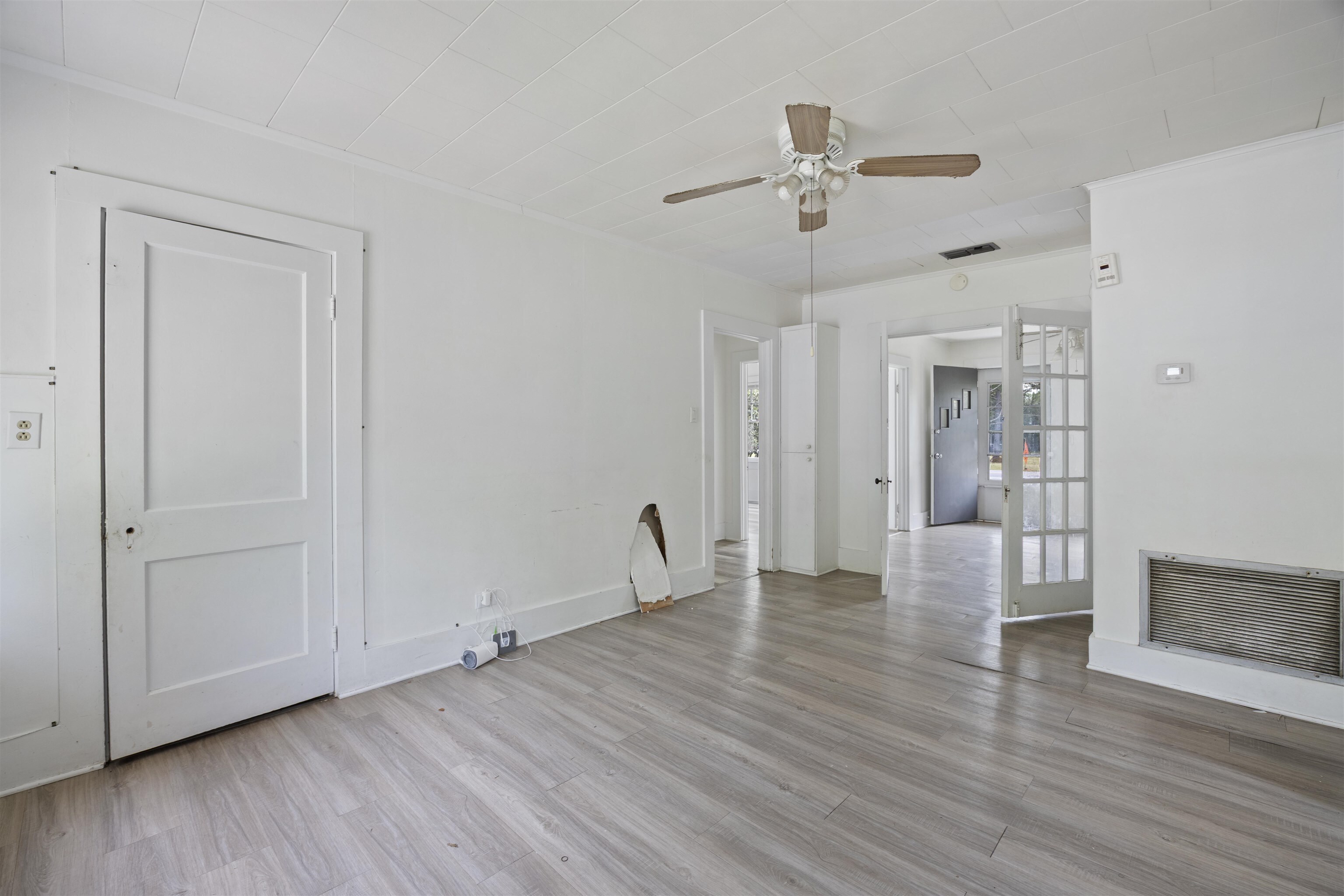 112 South Juniper Street Foley, AL 36535 - Photo 40 of 64 Unfurnished living room featuring a ceiling fan, light wood-style floors, and crown molding