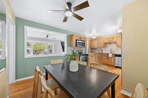 a view of a dining room with furniture and a potted plant