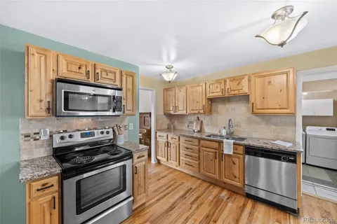 a kitchen with stainless steel appliances a stove sink and microwave
