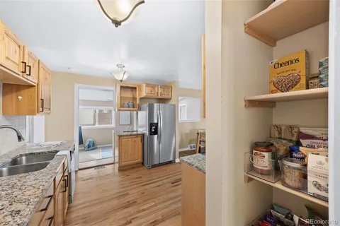 a kitchen with a refrigerator and a stove top oven