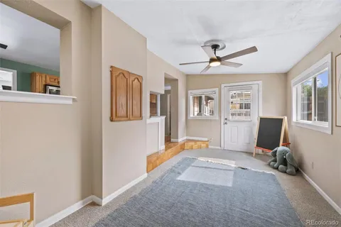 a view of a livingroom with workspace and a window