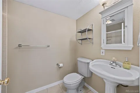 a bathroom with a sink toilet and a mirror