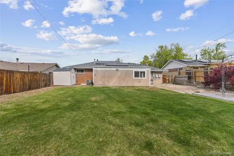 a view of a house with a backyard