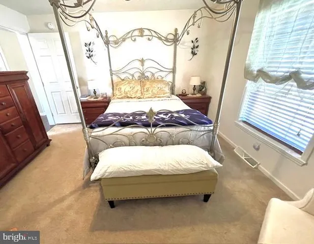 a bedroom with furniture and a chandelier