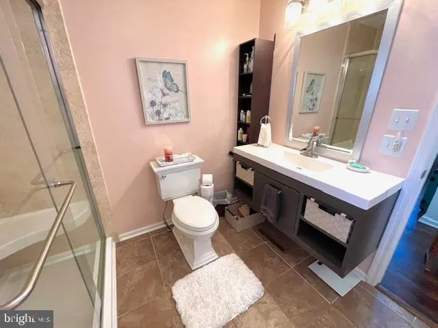 a white toilet sitting next to a bathroom sink