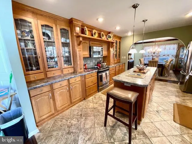 a kitchen with cabinets and chairs