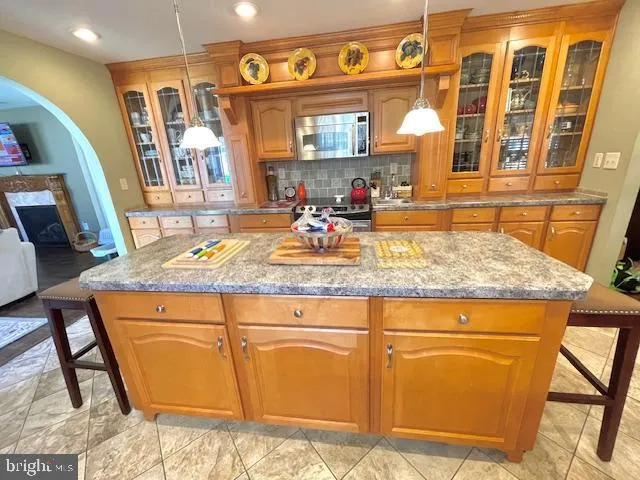 a large kitchen with a table and chairs in it