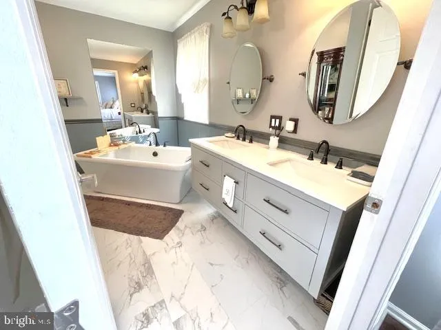a bathroom with a double vanity sink mirror and
