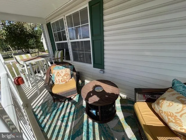 a view of a dining room with furniture wooden floor and a chandelier