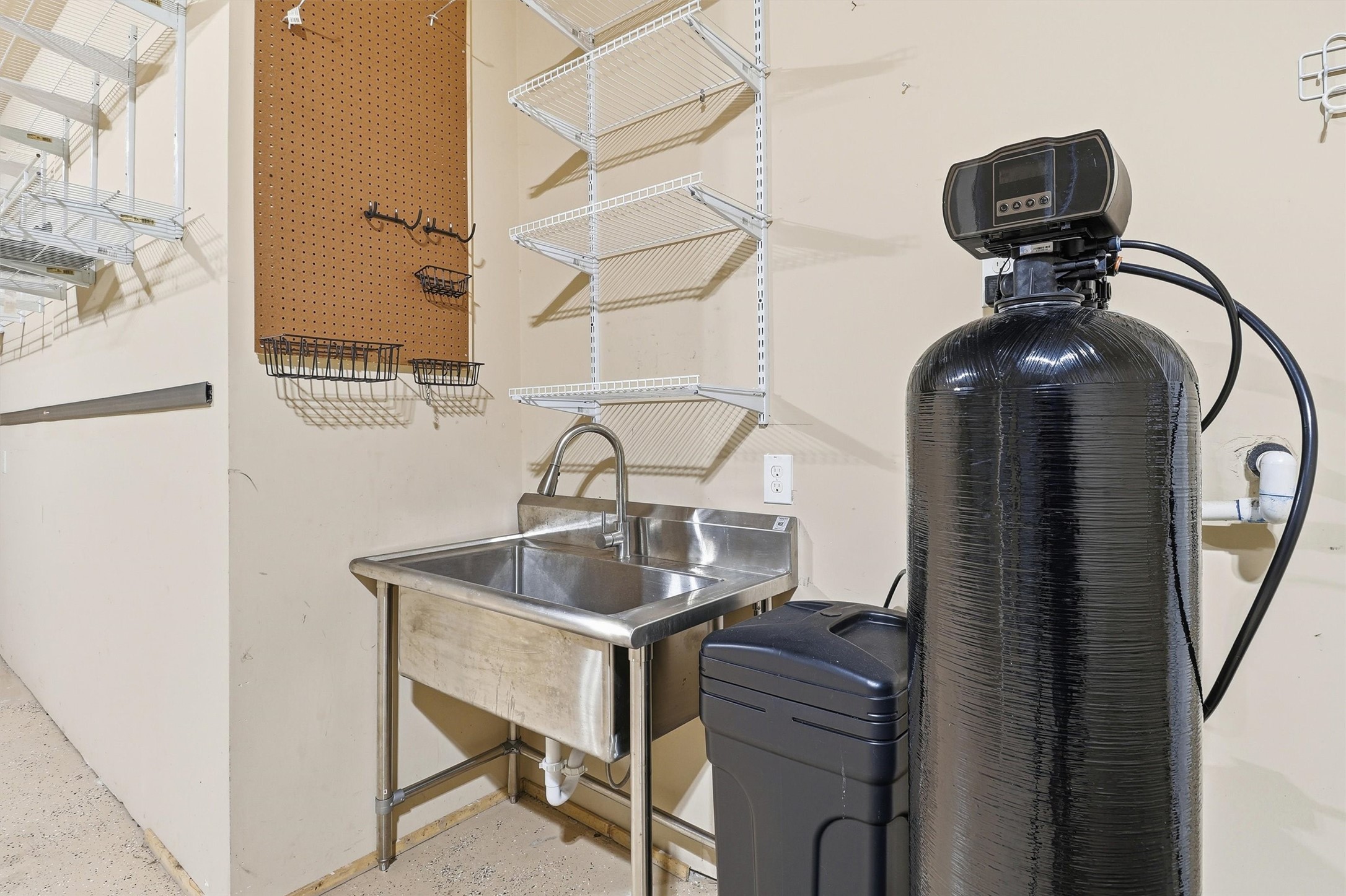 26202 Rustic Ranch Lane Katy, TX 77494 - Photo 50 of 50 Garage includes a sink, shelving, and GE water softener.