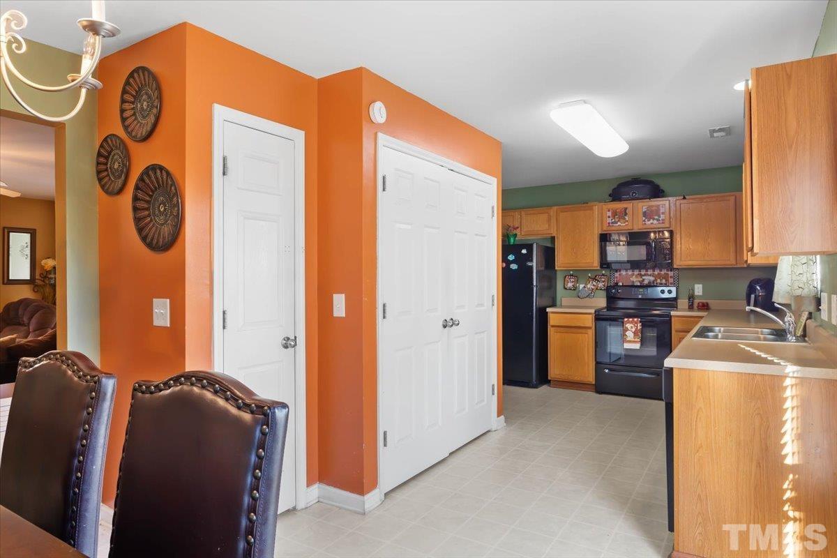 4262 Dalcross Road Raleigh, NC 27610 - Photo 12 of 27 a kitchen with stainless steel appliances granite countertop a refrigerator and a stove