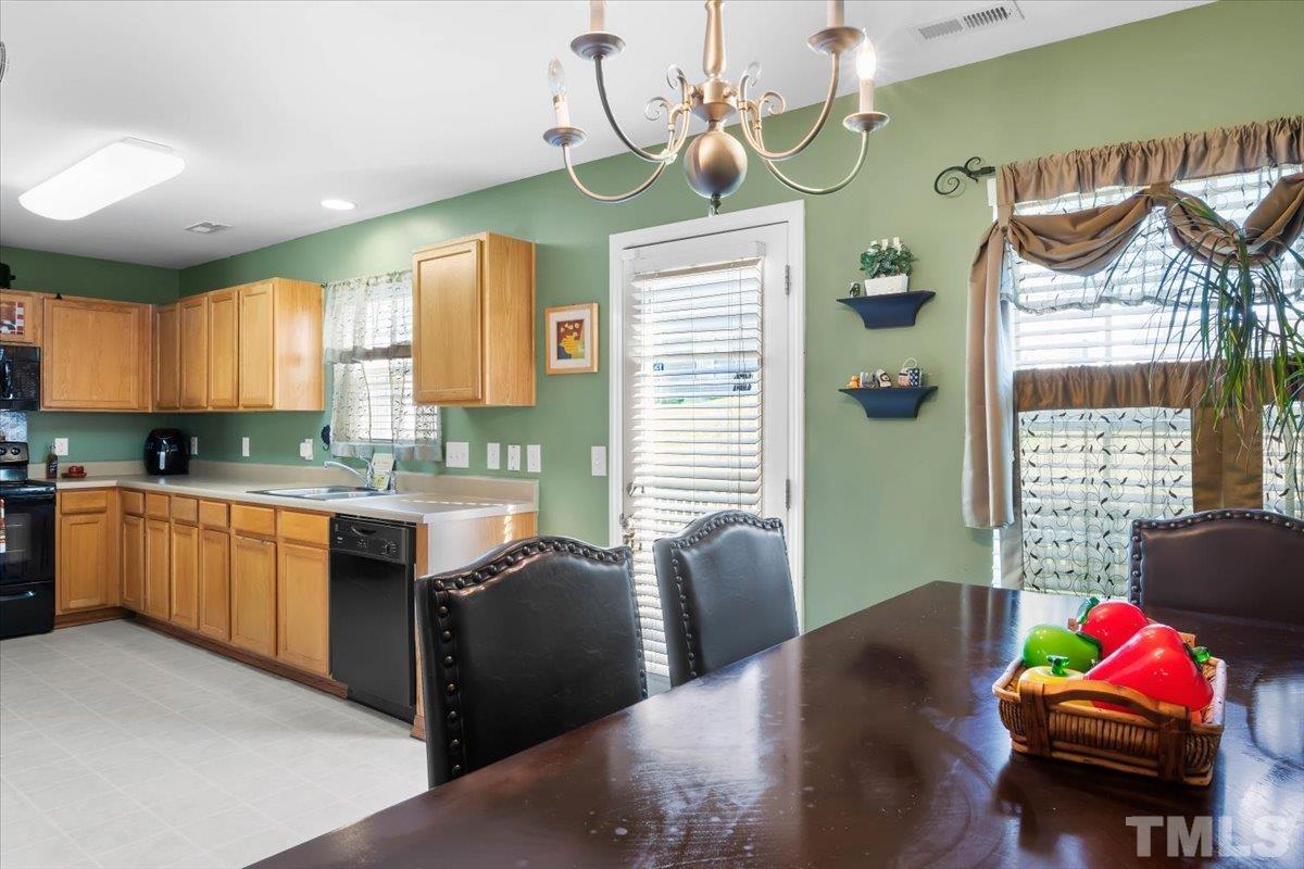 4262 Dalcross Road Raleigh, NC 27610 - Photo 13 of 27 a kitchen with granite countertop sink stove and refrigerator